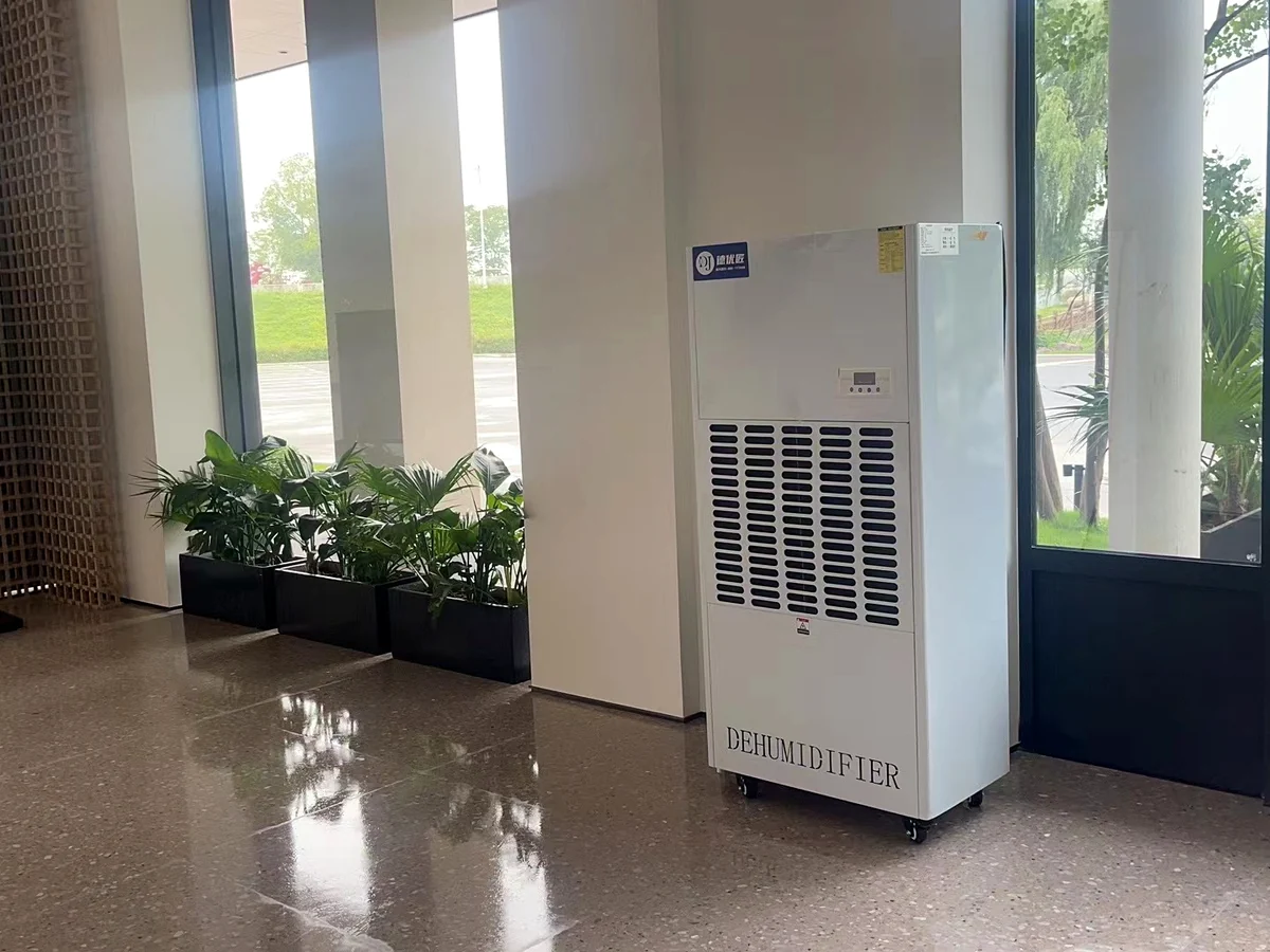 Floor-standing industrial dehumidifier installed in a public indoor space